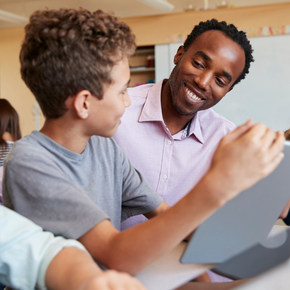 Teacher working with student in classroom